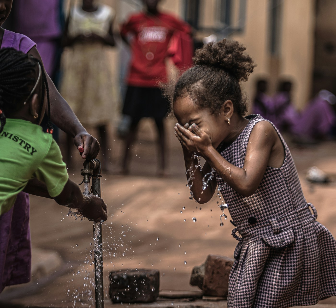 A child refreshing with clean water in the community